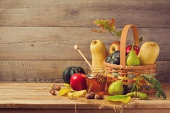 Autumn Nature Concept. Fall Fruits And Pumpkin On Wooden Table. Thanksgiving Dinner Stock Photo Autumn Nature Concept. Fall Fruits And Pumpkin On Wooden Table. Thanksgiving Dinner Stock Photo