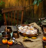 Autumn Outdoor Still Life With Pumpkin Cinnamon Buns In Oval Glass Dish On Wooden Table Stock Image
