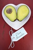 Avocado Cut In Half On Heart Shape Plate Stock Photo