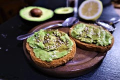 Avocado toast , overhead viewy avocado sandwich vocado paste on the black background royalty free stock images Avocado toast , overhead viewy avocado sandwich vocado paste on the black background royalty free stock images