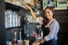 Aziatische vrouwen Barista die en koffiemachine in koffie s glimlachen met behulp van Stock Foto Aziatische vrouwen Barista die en koffiemachine in koffie s glimlachen met behulp van Stock Foto