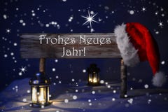 Año Nuevo de Santa Hat Frohes Neues Means de la luz de una vela de la muestra de la Navidad Imagen de archivo