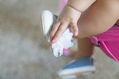 Babies take their blue shoe handles. royalty free stock image Babies take their blue shoe handles. royalty free stock image