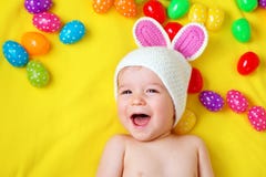 Baby boy in bunny hat lying on yellow blanket with easter eggs Royalty Free Stock Images Baby boy in bunny hat lying on yellow blanket with easter eggs Royalty Free Stock Images