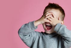 Baby boy kid covering close his eyes with hands and palms screaming laughing over pink royalty free stock photos Baby boy kid covering close his eyes with hands and palms screaming laughing over pink royalty free stock photos
