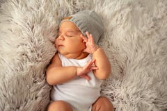 Boy kid newborn sleeping in hat on fluffy blanket stock image Boy kid newborn sleeping in hat on fluffy blanket stock image