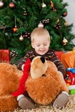 Baby Boy Playing With A Teddy Bear At Christmas Stock Photo
