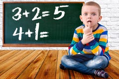 Baby boy solve mathematics examples.The student thinks and feels near the Board.Mathematical tasks . royalty free stock images Baby boy solve mathematics examples.The student thinks and feels near the Board.Mathematical tasks . royalty free stock images