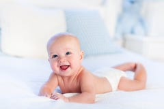 Baby boy on white bed