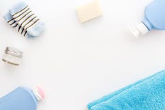 Baby care. Bath cosmetics and accessories for child. Shampoo, gel, cream, towel, socks on white background top view copy stock image Baby care. Bath cosmetics and accessories for child. Shampoo, gel, cream, towel, socks on white background top view copy stock image