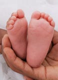 Baby Feet On White With Mom S Hands Royalty Free Stock Photography