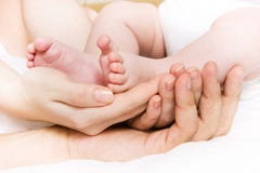 Baby Foots In Hands Of Parents Royalty Free Stock Photo