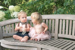 Baby girl and boy sitting on wooden bench royalty free stock photos Baby girl and boy sitting on wooden bench royalty free stock photos