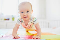 Baby Girl Learning To Crawl Stock Image