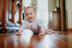 Baby Girl Learning To Crawl Stock Photo