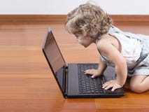 Baby girl using a laptop computer royalty free stock images Baby girl using a laptop computer royalty free stock images
