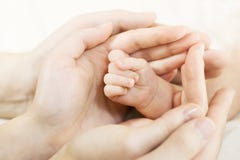 Baby hand into parents hands. Family concept stock photography Baby hand into parents hands. Family concept stock photography