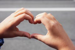 Hands folded heart. The concept of peace, friendship and love stock photo Hands folded heart. The concept of peace, friendship and love stock photo