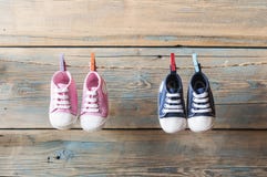 Baby shoes hanging on the clothesline. Stock Photo Baby shoes hanging on the clothesline. Stock Photo