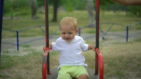A baby is swinging on the playground. royalty free stock images A baby is swinging on the playground. royalty free stock images
