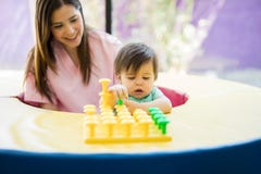 Baby and therapist playing with toys royalty free stock images Baby and therapist playing with toys royalty free stock images