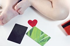 Babybeine und -Kreditkarten auf weißem Hintergrund, Herzbaby Stockfotografie Babybeine und -Kreditkarten auf weißem Hintergrund, Herzbaby Stockfotografie