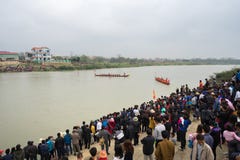 Bac Ninh, Vietnam - Feb 7, 2017: Cheering audiences at traditional boat racing spring festival on Cau river, Bac Ninh province Royalty Free Stock Image Bac Ninh, Vietnam - Feb 7, 2017: Cheering audiences at traditional boat racing spring festival on Cau river, Bac Ninh province Royalty Free Stock Image