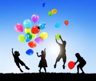 Back Lit Children Playing Balloons Together Outdoors stock images Back Lit Children Playing Balloons Together Outdoors stock images