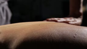 Close-up back massage in spa salon. massage therapist does a classic massage on a female body stock video footage Close-up back massage in spa salon. massage therapist does a classic massage on a female body stock video footage