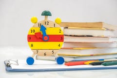 Back to school background with books and alarm clock over chalkboard. 12 o`clock. Time management concept. Close-up Of Alarm Clock Royalty Free Stock Images Back to school background with books and alarm clock over chalkboard. 12 o`clock. Time management concept. Close-up Of Alarm Clock Royalty Free Stock Images