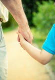 Back view of child and senior man holding hand stock images Back view of child and senior man holding hand stock images