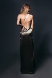 Incognito blondie with nude shoulder posing at long dress. royalty free stock photos Incognito blondie with nude shoulder posing at long dress. royalty free stock photos