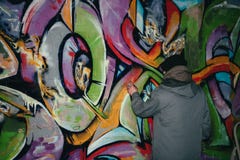 back view of street artist painting graffiti with aerosol paint on wall royalty free stock photo back view of street artist painting graffiti with aerosol paint on wall royalty free stock photo