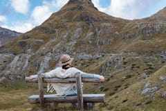 Back view of young lady with hat and warm poncho on mountain lan Stock Images Back view of young lady with hat and warm poncho on mountain lan Stock Images