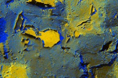 The background of blue and yellow paint with cracks on a rough wall. stock photography The background of blue and yellow paint with cracks on a rough wall. stock photography