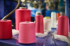 Background With A Lot Of Pink And White Coils With Threads. Bobbins Are Stacked In A Rows, One On The Other. Selective Focus Royalty Free Stock Photography