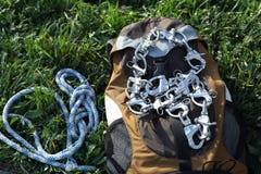Backpack with climbing equipment on green grass outdoors