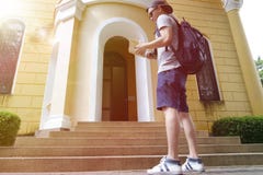 Backpacker looking at guidebook Backpacker looking at guidebook