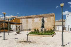 Baeza, Spain - 5/7/18: Courtyard with statue next to Church Of Santa Cruz. stock image Baeza, Spain - 5/7/18: Courtyard with statue next to Church Of Santa Cruz. stock image