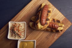 Baked hot dogs in a cheese bun with cabbage salad and souce stock photos Baked hot dogs in a cheese bun with cabbage salad and souce stock photos