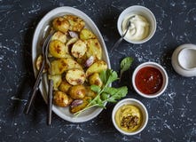 Baked potatoes and sauce him - homemade mayonnaise, ketchup and mustard. Delicious lunch or snack. royalty free stock photography Baked potatoes and sauce him - homemade mayonnaise, ketchup and mustard. Delicious lunch or snack. royalty free stock photography