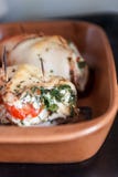 Baked poultry fillet stuffed with soft cheese, tomatoes and herb stock photography Baked poultry fillet stuffed with soft cheese, tomatoes and herb stock photography