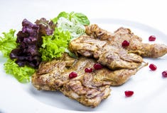 Baked quails with greens on a white plate stock photography Baked quails with greens on a white plate stock photography