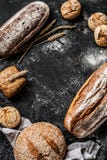Bakery - rustic crusty loaves of bread and buns on black royalty free stock photography Bakery - rustic crusty loaves of bread and buns on black royalty free stock photography