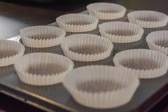 Baking tin with empty muffin cups made of baking paper stock photo Baking tin with empty muffin cups made of baking paper stock photo