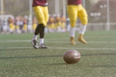 Ball and American football players on the field royalty free stock photo Ball and American football players on the field royalty free stock photo