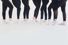 Ballet dancer tying ballet shoes. Close up ballet girl putting on her pointe shoes sitting on the floor, blurred stock image Ballet dancer tying ballet shoes. Close up ballet girl putting on her pointe shoes sitting on the floor, blurred stock image