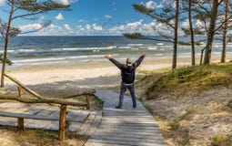 Happy senior tourist is resting near a beach of the Baltic Sea Royalty Free Stock Image Happy senior tourist is resting near a beach of the Baltic Sea Royalty Free Stock Image