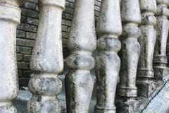 Balusters made of stone on the old historic staircase. Ruins of vintage balusters. Gray, weathered stone balusters. The royalty free stock photos Balusters made of stone on the old historic staircase. Ruins of vintage balusters. Gray, weathered stone balusters. The royalty free stock photos