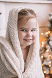 Bambina sveglia coperta in un grande plaid o sciarpa a casa fotografia stock libera da diritti Bambina sveglia coperta in un grande plaid o sciarpa a casa fotografia stock libera da diritti